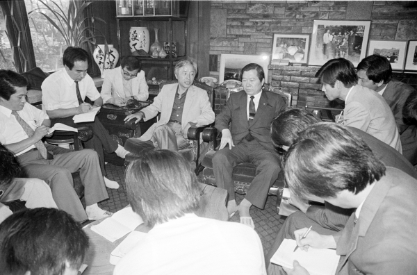 1985년 2월 12일 신민당이 12대 총선에서 성공을 거둔 이후 귀국한 DJ와  YS가 만나 기자들에게 둘러싸여 정국 구상에 대해 논의하고 있다.©연합뉴스